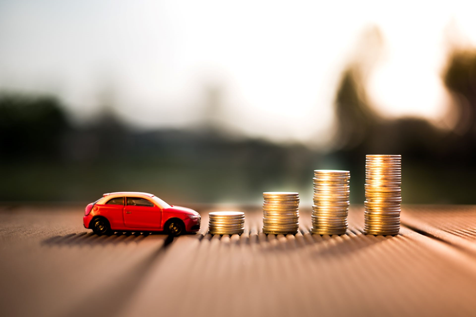 Red Toy car with stacks of coins